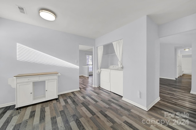 living room featuring separate washer and dryer and dark wood-type flooring