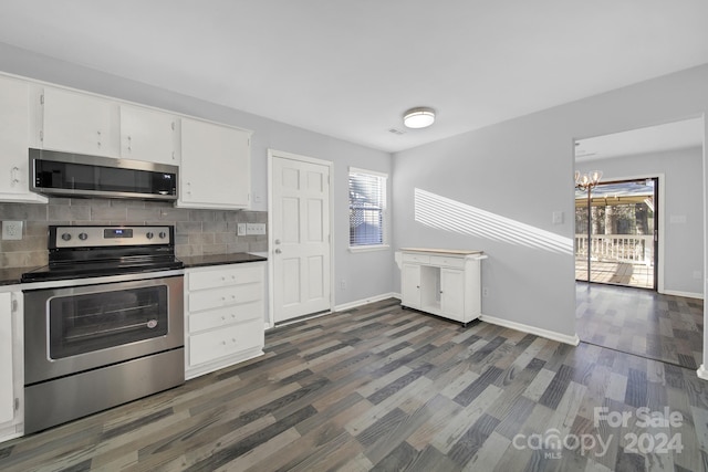 kitchen with stainless steel appliances, dark hardwood / wood-style flooring, backsplash, a chandelier, and white cabinets