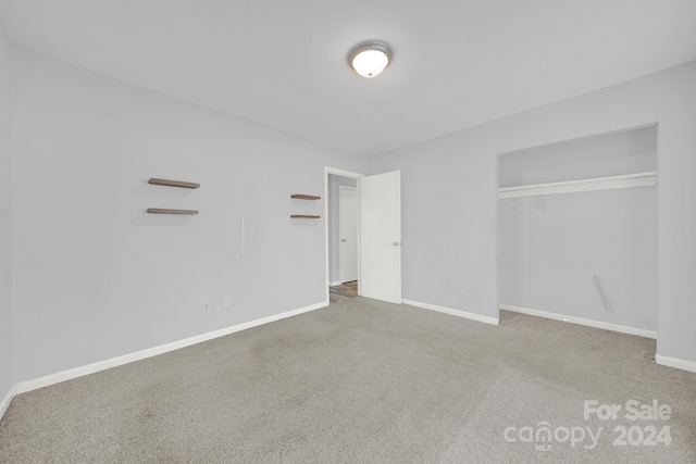 unfurnished bedroom with carpet and a closet