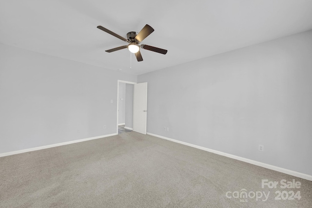 empty room with carpet flooring and ceiling fan