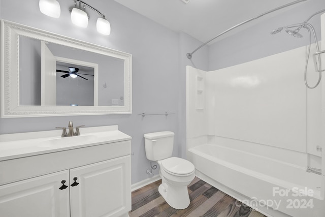 full bathroom featuring vanity, shower / washtub combination, ceiling fan, hardwood / wood-style flooring, and toilet