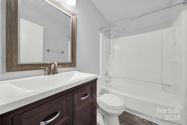 full bathroom with vanity, shower / washtub combination, vaulted ceiling, hardwood / wood-style flooring, and toilet