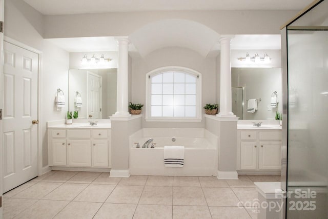 bathroom with tile patterned floors, shower with separate bathtub, vanity, and ornate columns