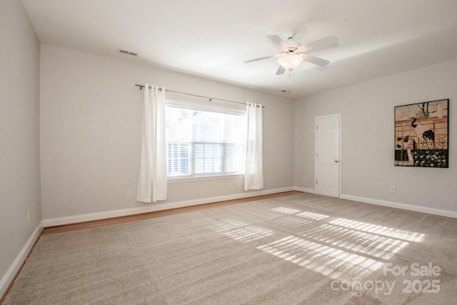 carpeted empty room featuring ceiling fan