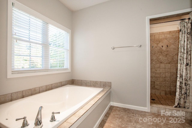 bathroom with independent shower and bath and tile patterned floors