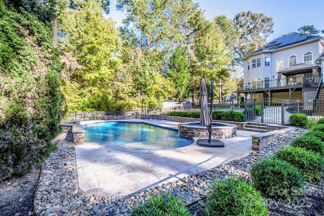 view of pool with an in ground hot tub and a patio area