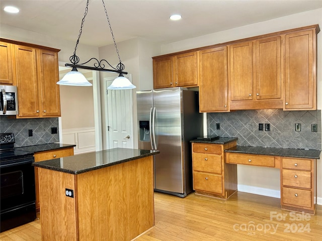 kitchen with pendant lighting, light hardwood / wood-style flooring, tasteful backsplash, a kitchen island, and stainless steel appliances