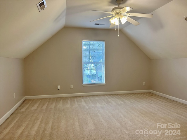 additional living space with light carpet, vaulted ceiling, and ceiling fan