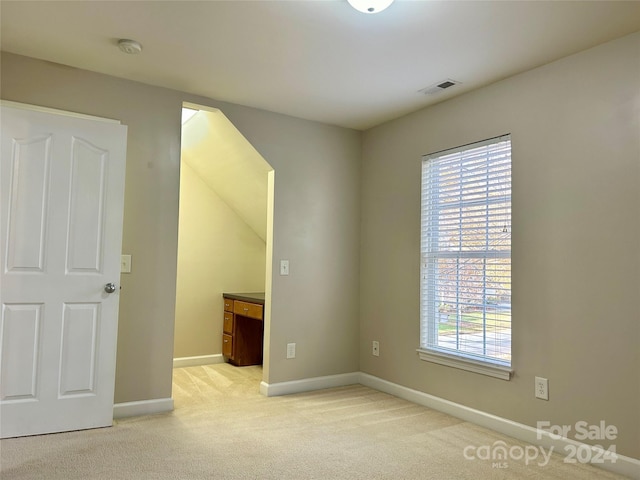 empty room featuring light carpet