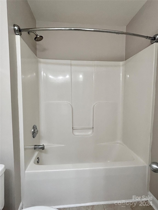 bathroom with shower / bath combination and toilet