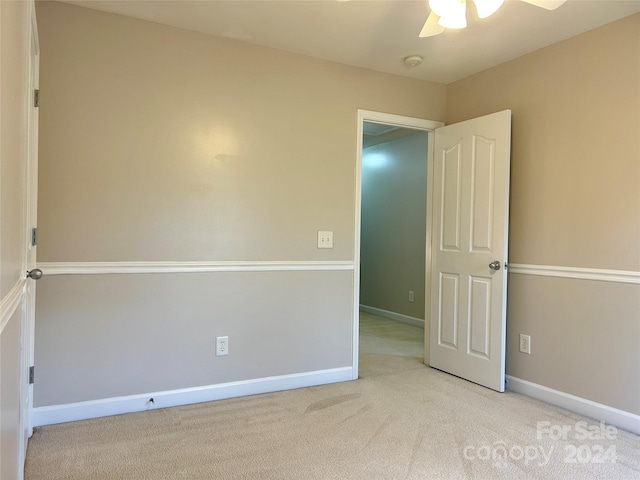 carpeted empty room with ceiling fan