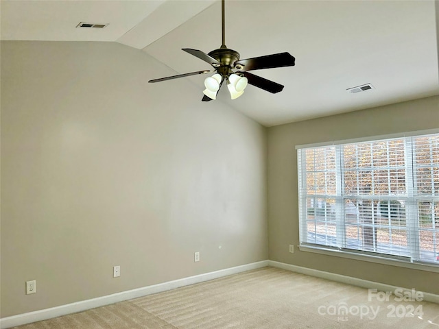 carpeted empty room with ceiling fan and lofted ceiling