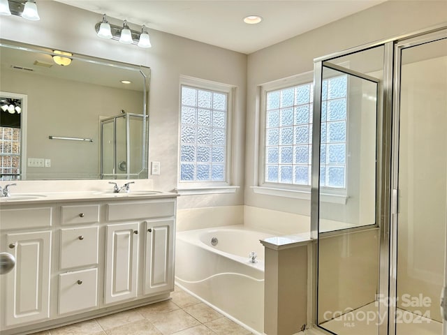 bathroom with tile patterned floors, vanity, and separate shower and tub