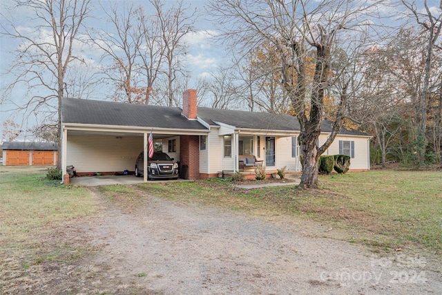 ranch-style home with a front yard, a porch, and a carport