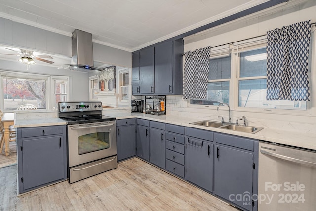 kitchen featuring sink, light hardwood / wood-style flooring, island range hood, appliances with stainless steel finishes, and ornamental molding