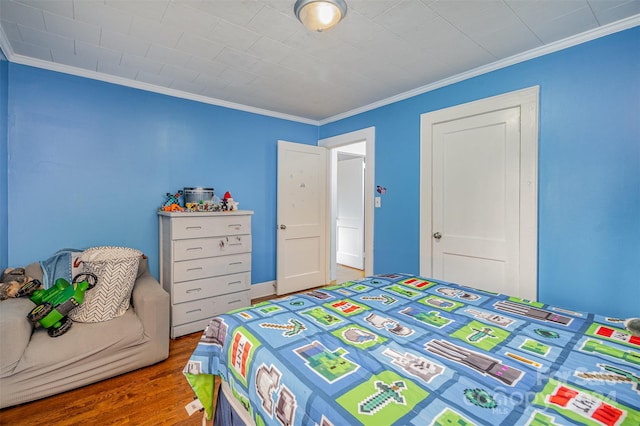 bedroom featuring crown molding and hardwood / wood-style floors