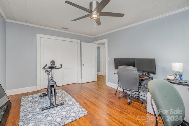 office featuring hardwood / wood-style floors, ceiling fan, and crown molding