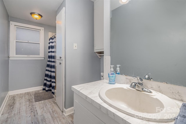 bathroom featuring a shower with curtain, hardwood / wood-style floors, and sink