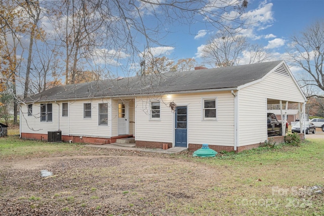 ranch-style home with central air condition unit and a front yard