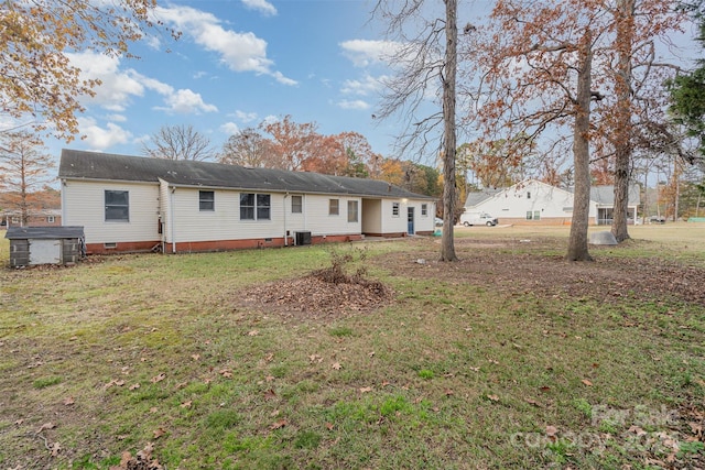 back of house featuring a lawn and central AC unit