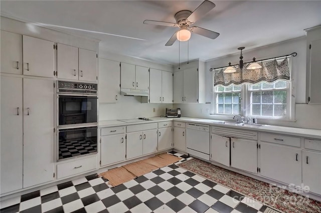 kitchen featuring white dishwasher, white cabinets, sink, double oven, and decorative light fixtures