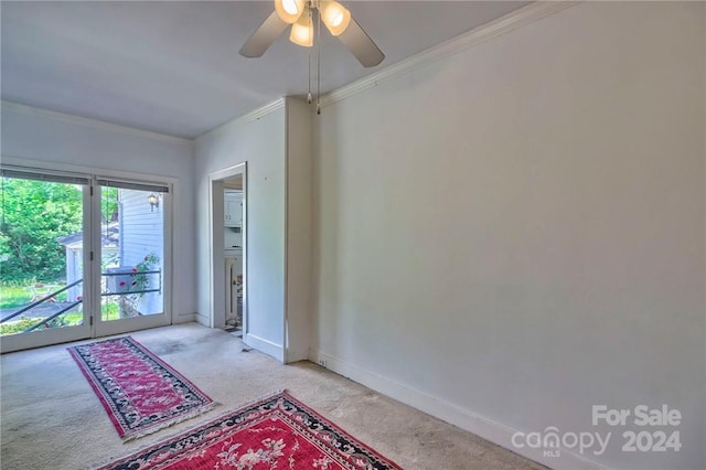 doorway featuring light carpet, ceiling fan, and crown molding