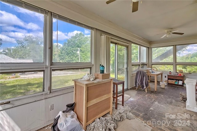 sunroom with ceiling fan and a healthy amount of sunlight