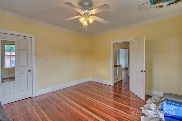 unfurnished bedroom with wood-type flooring, a closet, ceiling fan, and ornamental molding