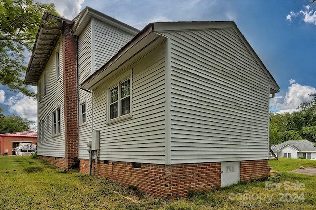 view of property exterior featuring a lawn