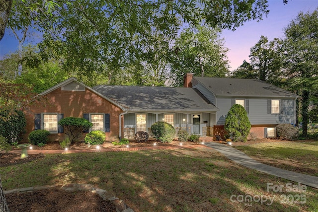 view of front of home with a lawn