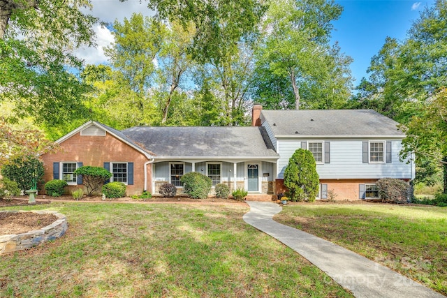 split level home featuring a front lawn and a porch