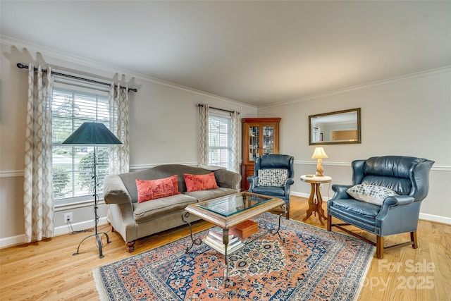 living room featuring hardwood / wood-style flooring, a healthy amount of sunlight, and ornamental molding