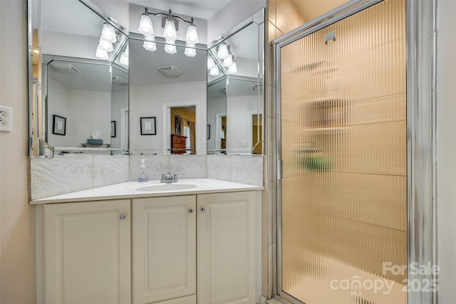 bathroom with backsplash, vanity, tile walls, and walk in shower