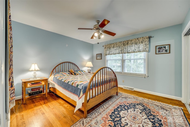 bedroom with wood-type flooring and ceiling fan