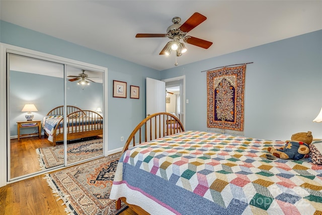 bedroom with hardwood / wood-style floors, a closet, and ceiling fan