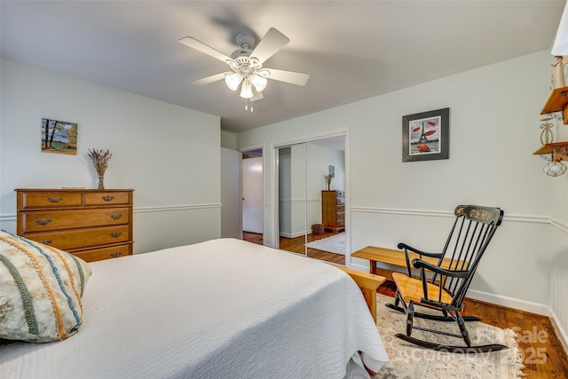 bedroom featuring ceiling fan, a closet, and wood-type flooring