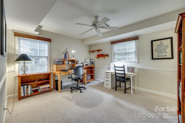 carpeted office space with ceiling fan