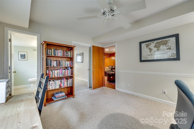 carpeted office featuring ceiling fan