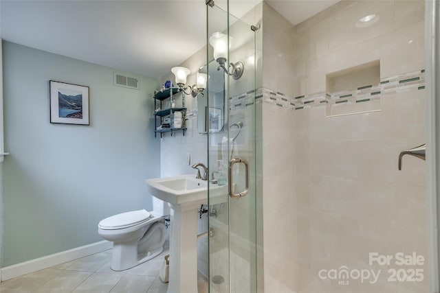 bathroom featuring an enclosed shower, tile patterned flooring, and toilet