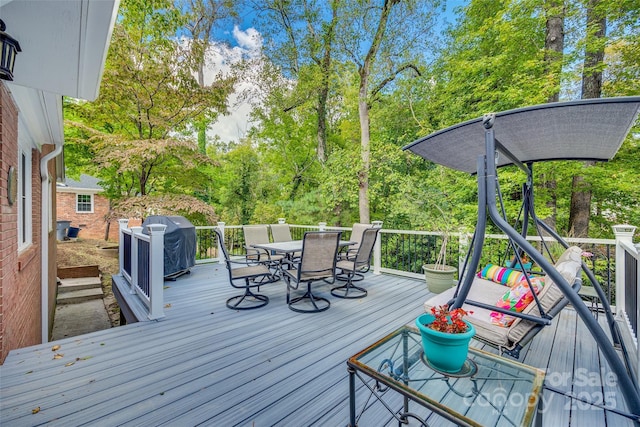 wooden deck with a grill