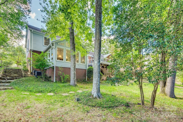 view of yard featuring a sunroom and cooling unit