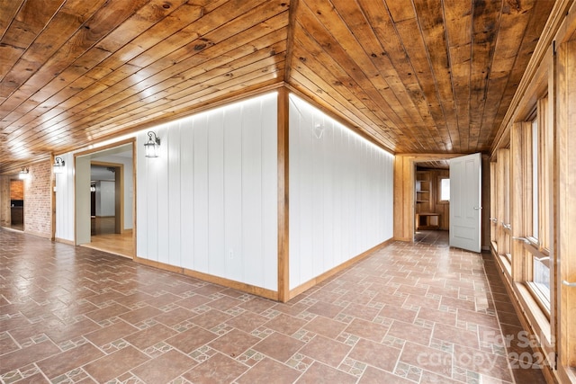 interior space featuring wooden walls, vaulted ceiling, and wooden ceiling