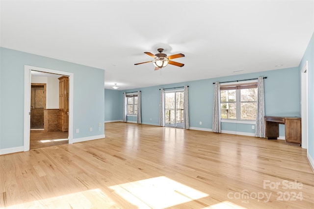 unfurnished living room featuring ceiling fan and light hardwood / wood-style flooring