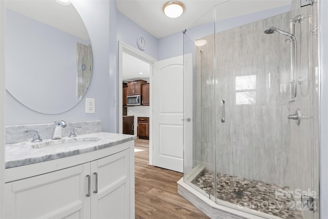 bathroom featuring vanity, hardwood / wood-style flooring, and walk in shower