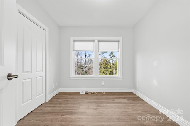 empty room with light hardwood / wood-style floors