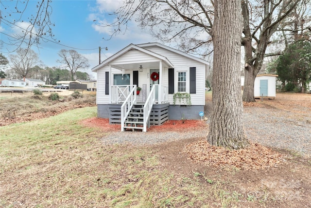 view of front of home with a storage shed