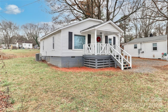 bungalow-style house with a front lawn and central AC unit