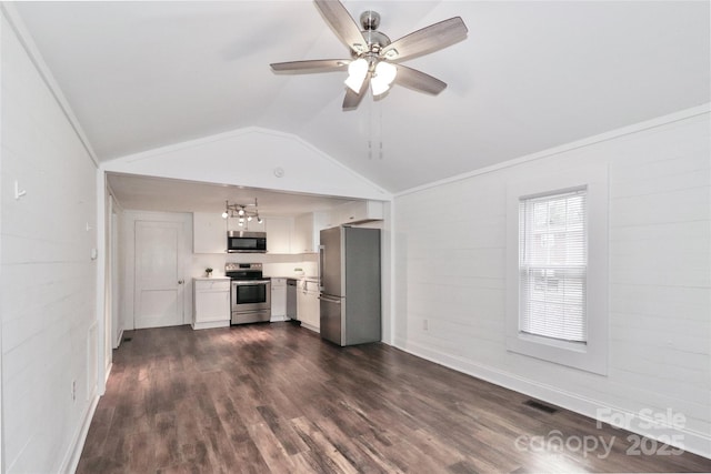 kitchen with lofted ceiling, white cabinetry, dark hardwood / wood-style floors, ceiling fan, and stainless steel appliances