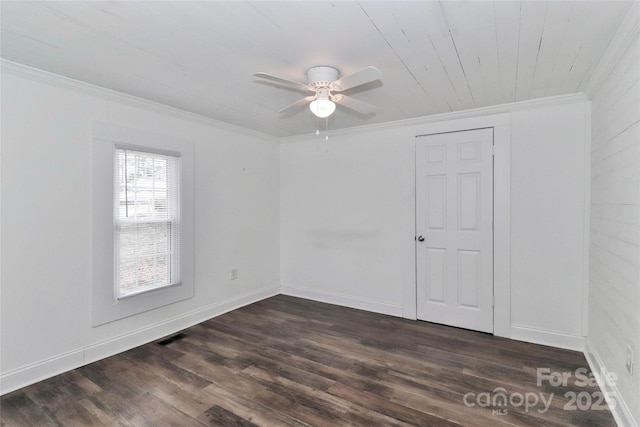 spare room with wood ceiling, ceiling fan, ornamental molding, and dark hardwood / wood-style flooring