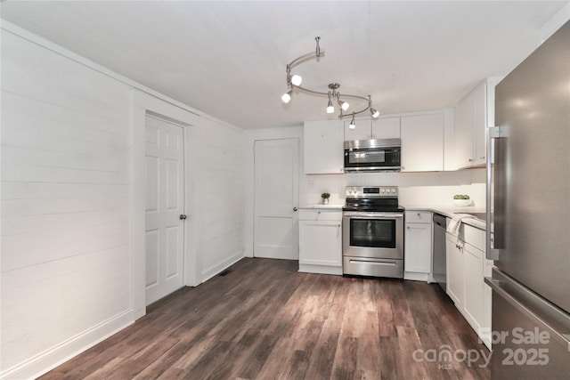 kitchen with white cabinetry, backsplash, dark wood-type flooring, and stainless steel appliances